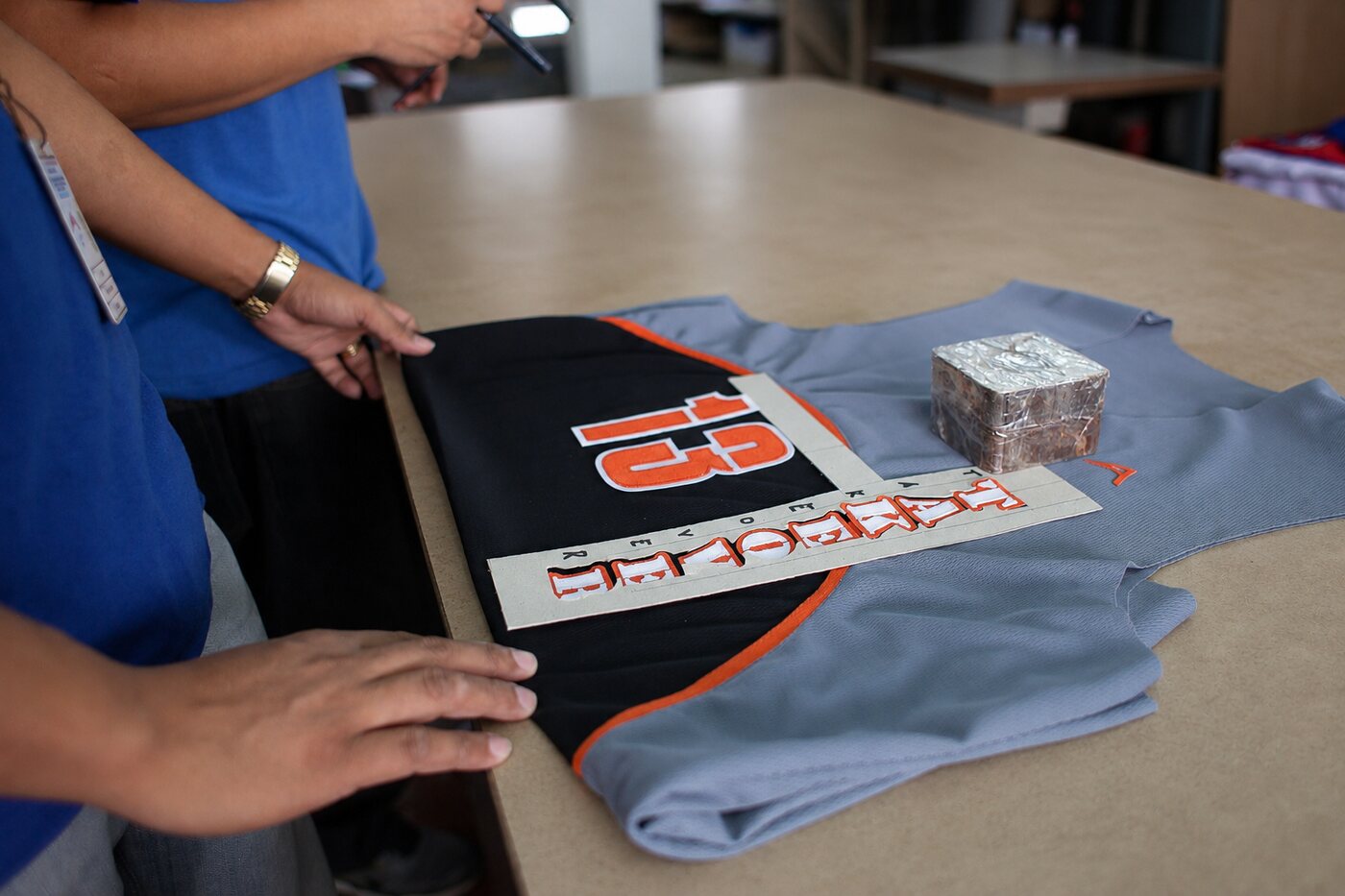 Hand-finishing a nameplate at Allen Sportswear