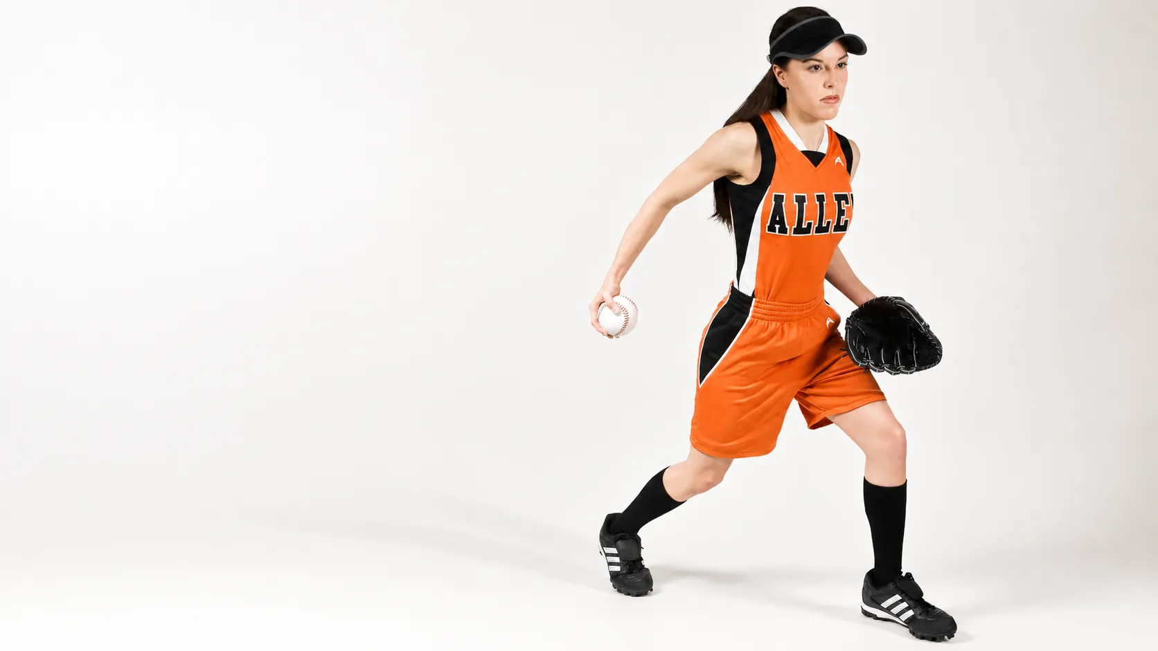 Softball player in a custom Allen Sportswear uniform